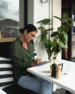 Woman using a laptop while sitting outside